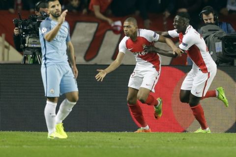 Monaco's Kylian Mbappe, center, celebrates after scoring his side's first goal during a Champions League round of 16 second leg soccer match between Monaco and Manchester City at the Louis II stadium in Monaco, Wednesday March 15, 2017. (AP Photo/Claude Paris)