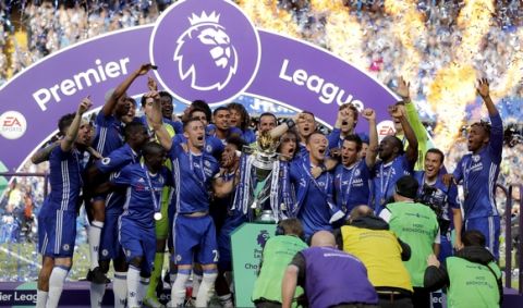 Chelsea captain John Terry, right, and Gary Cahill raise the trophy after they won the league, following the English Premier League soccer match between Chelsea and Sunderland at Stamford Bridge stadium in London, Sunday, May 21, 2017. (AP Photo/Frank Augstein)