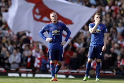Manchester United's Wayne Rooney, left and Manchester United's Phil Jones react after conceding a goal during the English Premier League soccer match between Arsenal and Manchester United at the Emirates stadium in London, Sunday, May 7, 2017. (AP Photo/Matt Dunham)