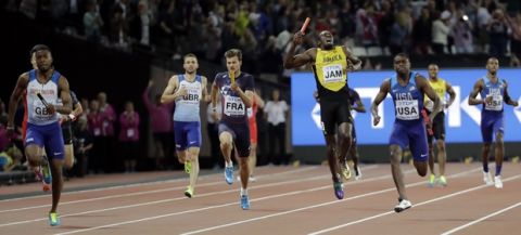 Jamaica's Usain Bolt, center, pulls up injured in the final of the Men's 4x100m relay during the World Athletics Championships in London Saturday, Aug. 12, 2017. At right is United States' Christian Coleman and left Britain's Nathaneel Mitchell-Blake who took the gold. (AP Photo/David J. Phillip)