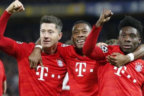 Bayern's Robert Lewandowski, left, celebrates his side's third goal with his teammates during the Champions League round of 16 soccer match between Chelsea and Bayern Munich at Stamford Bridge in London, England, Tuesday, Feb. 25, 2020. (AP Photo/Frank Augstein)