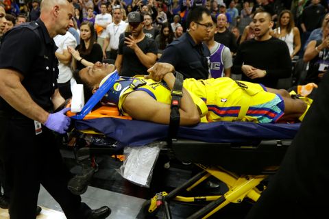 Golden State Warriors guard Patrick McCaw is taken off the court on a stretcher after falling hard to the floor late in the third quarter following a Flagrant 1 foul by Sacramento Kings's Vince Carter in an NBA basketball game Saturday, March 31, 2018, in Sacramento, Calif. The Warriors won 112-96. (AP Photo/Rich Pedroncelli)
