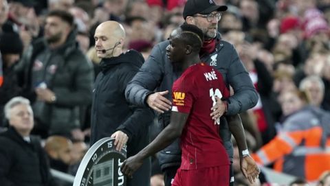 Liverpool's manager Jurgen Klopp embraces Liverpool's Sadio Mane during the English Premier League soccer match between Liverpool and Sheffield United at Anfield Stadium, Liverpool, England, Thursday, Jan. 2, 2020. (AP Photo/Jon Super)