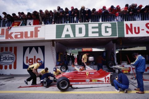 Gilles Villeneuve gestures for adjustments to be made on the #12 Scuderia Ferrari SpA SEFAC Ferrari 312T4 as spectators look on during practice for the Grand Prix of Austria on 11 August 1979 at the Osterreichring in Spielberg, Austria. (Photo Getty Images)  