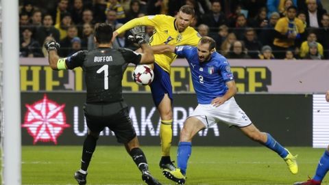 Italy goalkeeper Gianluigi Buffon, left, Sweden's Marcus Berg and Italy's Giorgio Chiellini, right, go for the ball during the World Cup qualifying play-off first leg soccer match between Sweden and Italy, at the Friends Arena in Stockholm, Friday, Nov. 10, 2017. (AP Photo/Frank Augstein)