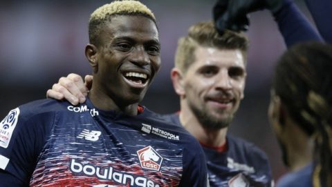 Lille's Victor Osimhen, left, reacts after scoring during his French League One soccer match between Lille and Brest at the Lille Metropole stadium, in Villeneuve d'Ascq, northern France, Friday, Dec. 6, 2019. (AP Photo/Michel Spingler)