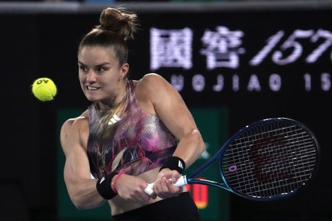Maria Sakkari of Greece plays a backhand return to Diana Shnaider of Russia during their second round match at the Australian Open tennis championship in Melbourne, Australia, Wednesday, Jan. 18, 2023. (AP Photo/Ng Han Guan)
