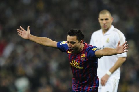 Barcelona's midfielder Xavi Hernandez celebrates after Real Madrid's Brazilian defender Marcelo scored an own goal during the "El clasico" Spanish League football match Real Madrid against Barcelona at the Santiago Bernabeu stadium in Madrid on December 10, 2011.   AFP PHOTO/JAVIER SORIANO (Photo credit should read JAVIER SORIANO/AFP/Getty Images)