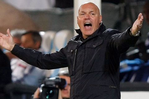 Marseille's French coach Jose Anigo gestures during their League One soccer match against Lyon at the Velodrome Stadium in Marseille, southern France, Sunday May 4, 2014. (AP Photo/Claude Paris)