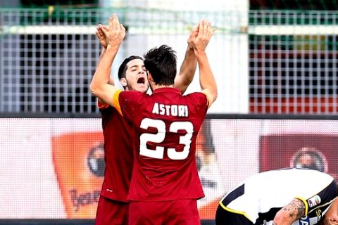 From left, Roma's Kostas Manolas, Davide Astori and Daniele De Rossi celebrate at the end at the end of the Serie A soccer match between Udinese and Roma at the Friuli Stadium in Udine, Italy, Tuesday, Jan. 6, 2015. Roma won 1-0. (AP Photo/Paolo Giovannini)