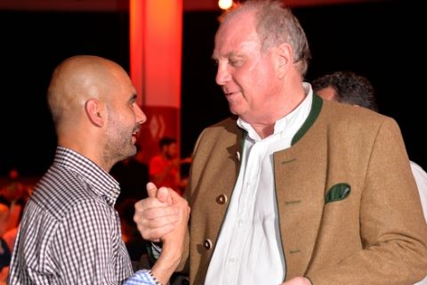 In this picture taken Saturday May 10, 2014, Pep Guardiola, head coach of Bayern Munich soccer club , left, greets former club president Uli Hoeness  during the official Champions party  in Munich , Germany.   (AP Photo/Stuart Franklin,Pool)