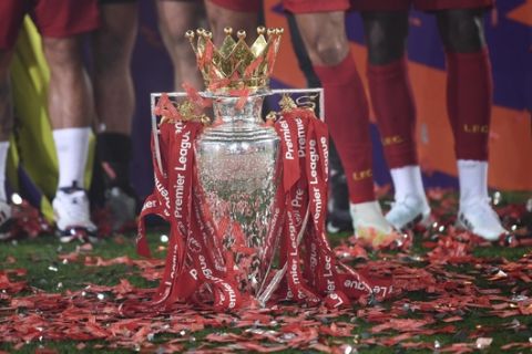 The English Premier League trophy is placed on the pitch after it was presented to Liverpool following the Premier League soccer match between Liverpool and Chelsea at Anfield stadium in Liverpool, England, Wednesday, July 22, 2020. (Paul Ellis, Pool via AP)