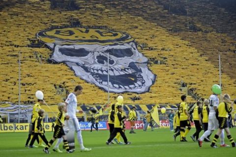 Thousands of Dortmund supporters show a giant skull on the tribune prior the German first division Bundesliga soccer match between Borussia Dortmund an VfL Wolfsburg in Dortmund, Germany, Saturday, Nov. 5, 2011. (AP Photo/Martin Meissner) - NO MOBILE USE UNTIL 2 HOURS AFTER THE MATCH, WEBSITE USERS ARE OBLIGED TO COMPLY WITH DFL-RESTRICTIONS, SEE INSTRUCTIONS FOR DETAILS -