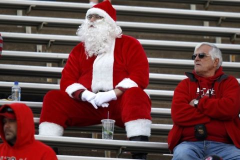 A man wearing a Santa Claus suit joins fans in the Utah fan section to watch the second half of Utah's 42-35 victory over Colorado in an NCAA college football game in Boulder, Colo., on Friday, Nov. 23, 2012. (AP Photo/David Zalubowski)