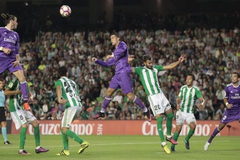 Real Madrid's Cristiano Ronaldo jumps for the ball against Betis during their La Liga soccer match at the Benito Villamarin stadium, in Seville, Spain on Saturday, Oct. 15, 2016. (AP Photo/Angel Fernandez