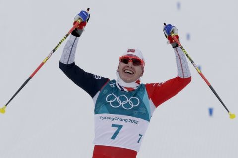 Simen Hegstad Krueger, of Norway, celebraates after winning the during the men's 15km/15km skiathlon cross-country skiing competition at the 2018 Winter Olympics in Pyeongchang, South Korea, Sunday, Feb. 11, 2018. (AP Photo/Kirsty Wigglesworth)