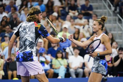 Stefanos Tsitsipas, left, and Maria Sakkari, of Greece, right, celebrate a point during "The Tennis Plays for Peace" exhibition match to raise awareness and humanitarian aid for Ukraine Wednesday, Aug. 24, 2022, in New York. The 2022 U.S. Open Main Draw will begin on Monday, Aug. 29, 2022. (AP Photo/Frank Franklin II)