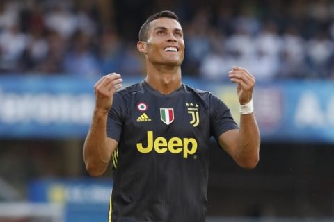 Juventus' Cristiano Ronaldo runs with the ball during the Serie A soccer match between Chievo Verona and Juventus, at the Bentegodi Stadium in Verona, Italy, Saturday, Aug. 18, 2018. (AP Photo/Antonio Calanni)