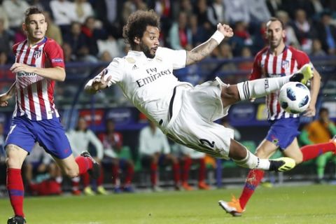 Real Madrid's Marcelo tries to shoot during the UEFA Super Cup final soccer match between Real Madrid and Atletico Madrid at the Lillekula Stadium in Tallinn, Estonia, Wednesday, Aug. 15, 2018. (AP Photo/Pavel Golovkin)