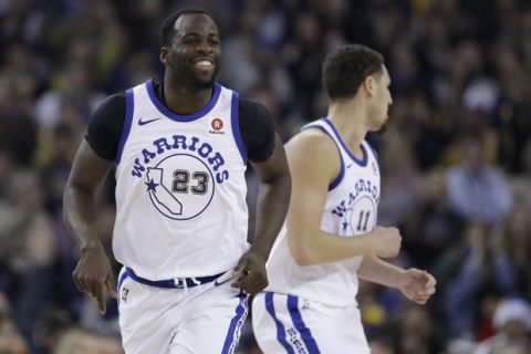 Golden State Warriors forward Draymond Green (23) smiles after scoring against the Los Angeles Lakers during the first half of an NBA basketball game Friday, Dec. 22, 2017, in Oakland, Calif. (AP Photo/Marcio Jose Sanchez)