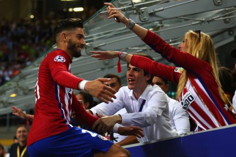 MILAN, ITALY - MAY 28:  Yannick Carrasco of Atletico Madrid.celebrates with a member of the crowd during the UEFA Champions League Final between Real Madrid and Club Atletico de Madrid at Stadio Giuseppe Meazza on May 28, 2016 in Milan, Italy.  (Photo by Steve Bardens - UEFA/UEFA via Getty Images)