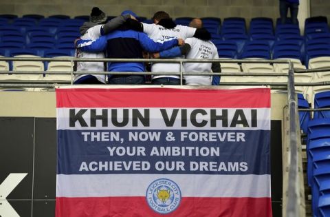 Leicester City fans above a flag remembering Vichai Srivaddhanaprabha that reads 'Khun Vichai Then, Now & Forever Your Ambition Achieved Our Dreams' before kick-off of the English Premier League soccer match between Cardiff City and Leicester City at the Cardiff City Stadium, Cardiff. Wales. Saturday Nov. 3, 2018. (Simon Galloway/PA via AP)