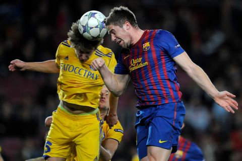 Barcelona's forward Andreu Fontas (R) vies with Bate's midfielder Dmitri Baga (L) during the Champions League football match between FC Barcelona and Bate Borissov at the Camp Nou stadium in Barcelona on December 6, 2011. AFP PHOTO/LLUIS GENE (Photo credit should read LLUIS GENE/AFP/Getty Images)