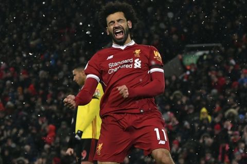 Liverpool's Mohamed Salah celebrates scoring his hat-trick during the English Premier League soccer match between Liverpool and Watford at Anfield, Liverpool, England, Saturday, March 17, 2018. (Anthony Devlin/PA via AP)