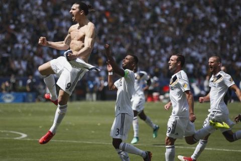 Los Angeles Galaxy's Zlatan Ibrahimovic, left, of Sweden, celebrates his goal during the second half of an MLS soccer match against the Los Angeles FC Saturday, March 31, 2018, in Carson, Calif. The Galaxy won 4-3. (AP Photo/Jae C. Hong)