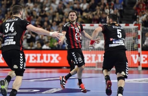 Vardar's Luka Cindric, center, celebrates after he scored the last goal of the Final Four Champions League handball semifinal between HC Vardar and FC Barcelona Lassa in Cologne, Germany, Saturday, June 3, 2017. Vardar defeated Barcelona with 26-25. (AP Photo/Martin Meissner)