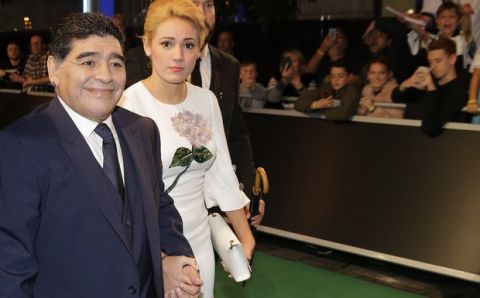 Argentina soccer legend Diego Armando Maradona and partner Rocio Olivia arrive for the The Best FIFA 2017 Awards at the Palladium Theatre in London, Monday, Oct. 23, 2017. (AP Photo/Alastair Grant)