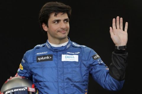 McLaren driver Carlos Sainz of Spain waves as he poses for a photo at the Australian Formula One Grand Prix in Melbourne, Thursday, March 12, 2020. (AP Photo/Rick Rycroft)