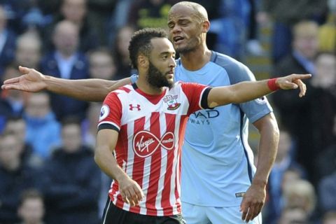 Southampton's Nathan Redmond, foreground, reacts after scoring as Manchester City's Vincent Kompany gestures, during the English Premier League soccer match between Manchester City and Southampton at the Etihad Stadium in Manchester, England, Sunday, Oct. 23, 2016. (AP Photo/Rui Vieira)