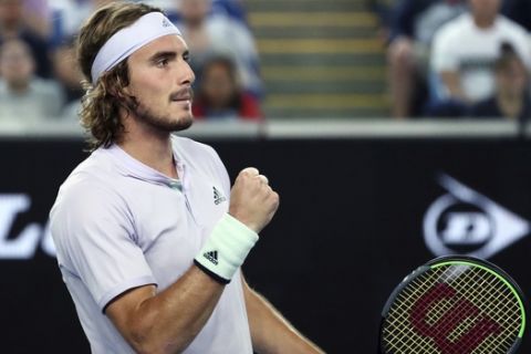 Stefanos Tsitsipas of Greece reacts after winning a point against Italy's Salvatore Caruso during their first round singles match the Australian Open tennis championship in Melbourne, Australia, Monday, Jan. 20, 2020. (AP Photo/Dita Alangkara)