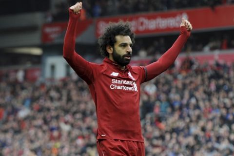 Liverpool's Mohamed Salah celebrates after scoring his side's second goal during the English Premier League soccer match between Liverpool and Chelsea at Anfield stadium in Liverpool, England, Sunday, April 14, 2019. (AP Photo/Rui Vieira)