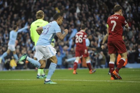 Manchester City's Gabriel Jesus, center, celebrates scoring his side's first goal during the Champions League quarterfinal second leg soccer match between Manchester City and Liverpool at Etihad stadium in Manchester, England, Tuesday, April 10, 2018. (AP Photo/Rui Vieira)