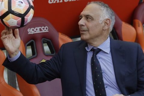 FILE - In this Sunday, May 28, 2017 file photo AS Roma president James Pallotta plays with a ball prior to an Italian Serie A soccer match between Roma and Genoa at the Olympic stadium in Rome, Sunday, May 28, 2017. A "Made in USA" matchup. The "American derby." Italian media are promoting Friday's match between AC Milan and Roma at the San Siro stadium as the first meeting of two American-owned clubs in Serie A. (AP Photo/Alessandra Tarantino, File)