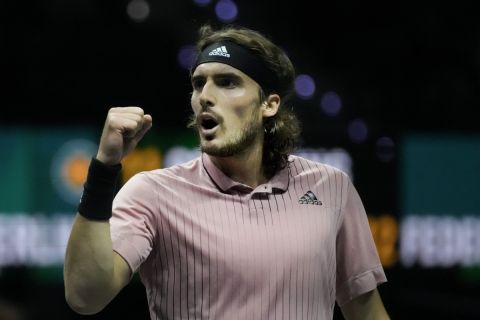 Stefanos Tsitsipas of Greece clenches his fist after winning the first set against Alex de Minaur of Australia in their quarterfinal men's singles match of the ABN AMRO world tennis tournament at Ahoy Arena in Rotterdam, Netherlands, Friday, Feb. 11, 2022. (AP Photo/Peter Dejong)