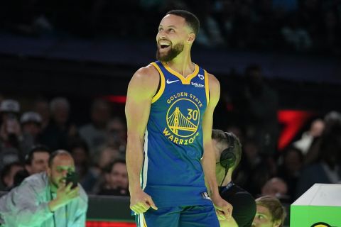 Golden State Warriors guard Stephen Curry reacts after winning a competition against Sabrina Ionescu at the NBA basketball All-Star weekend, Saturday, Feb. 17, 2024, in Indianapolis. (AP Photo/Darron Cummings)