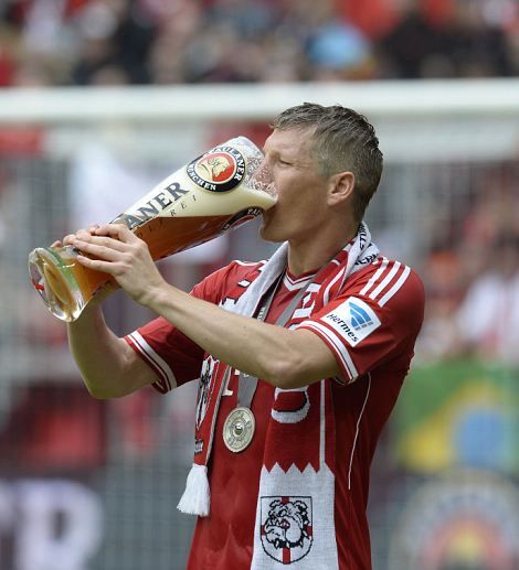 Bayern Munich's midfielder Bastian Schweinsteiger drinks a beer as he celebrates after winning 3:0 the German first division Bundesliga football match Bayern Munich vs FC Augsburg in Munich, southern Germany, on May 11, 2013. Munich were confirmed German league champions back on April 6, when they won the Bundesliga with a record six games left to play.  AFP PHOTO / CHRISTOF STACHE

RESTRICTIONS / EMBARGO - DFL RULES TO LIMIT THE ONLINE USAGE DURING MATCH TIME TO 15 PICTURES PER MATCH. IMAGE SEQUENCES TO SIMULATE VIDEO IS NOT ALLOWED AT ANY TIME.  FOR FURTHER QUERIES PLEASE  CONTACT THE  DFL DIRECTLY AT + 49 69 650050.CHRISTOF STACHE/AFP/Getty Images