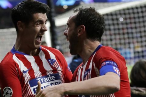 Atletico defender Diego Godin, right, celebrates after scoring his side's second goal with Alvaro Morata during the Champions League round of 16 first leg soccer match between Atletico Madrid and Juventus at Wanda Metropolitano stadium in Madrid, Wednesday, Feb. 20, 2019. Atletico won 2-0. (AP Photo/Manu Fernandez)