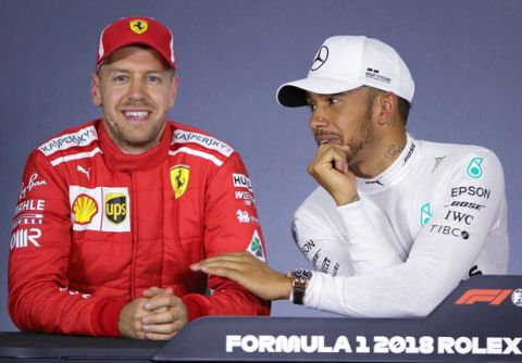 Mercedes driver Lewis Hamilton, right, of Britain, and Ferrari driver Sebastian Vettel of Germany laugh during a press conference following qualifying at the Australian Formula One Grand Prix in Melbourne, Saturday, March 24, 2018. Hamilton has poll ahead of Vettel and Ferrari driver Kimi Raikkonen of Finland is third on the start grid. (AP Photo/Asanka Brendon Ratnayake)