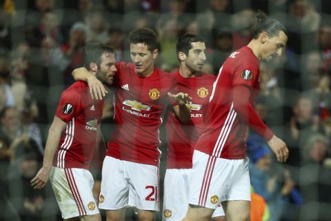 United players celebrate after Juan Mata, left, scored the opening goal during the Europa League round of 16, second leg, soccer match between Manchester United and FC Rostov at Old Trafford Stadium in Manchester, England, Thursday March 16, 2017. (AP Photo/Dave Thompson)