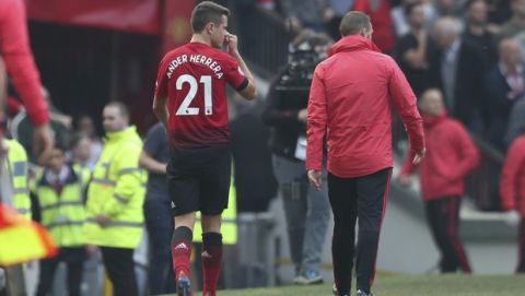 Manchester United's Ander Herrera walks off injured during the English Premier League soccer match between Manchester United and Liverpool at Old Trafford stadium in Manchester, England, Sunday, Feb. 24, 2019. (AP Photo/Jon Super)