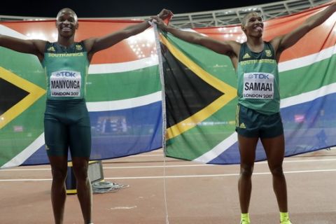South Africa's gold medal winner Luvo Manyonga, left, and bronze medal winner Ruswahl Samaai celebrate after the men's long jump final during the World Athletics Championships in London Saturday, Aug. 5, 2017. (AP Photo/Matthias Schrader)