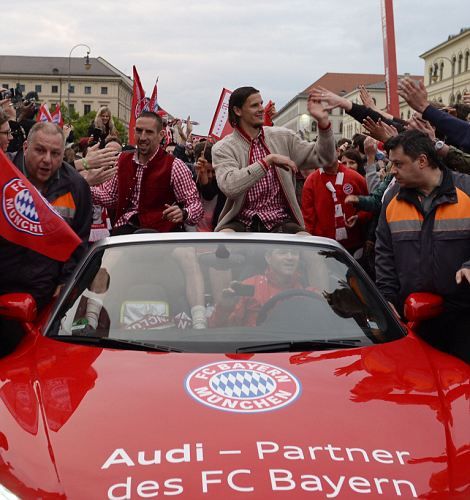 Bayern Munich's French midfielder Franck Ribery (C) and Bayern Munich's Belgian defender Daniel van Buyten (R) are congratulated by fans while sitting in a car on their way to the Marienplatz square to celebrate the German football league champion's title after the German first division Bundesliga football match between Bayern Munich and FC Augsburg in Munich, southern Germany, on May 11, 2013. Munich were confirmed German league champions back on April 6, when they won the Bundesliga with a record six games left to play. AFP PHOTO / CHRISTOF STACHECHRISTOF STACHE/AFP/Getty Images