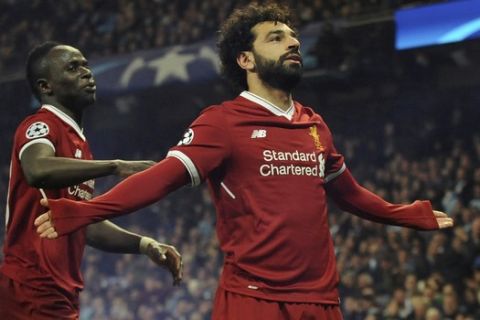 Liverpool's Mohamed Salah, right, celebrates scoring his side's first goal with Liverpool's Sadio Mane during the Champions League quarterfinal second leg soccer match between Manchester City and Liverpool at Etihad stadium in Manchester, England, Tuesday, April 10, 2018. (AP Photo/Rui Vieira)
