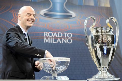 UEFA Secretary General  and FIFA president candidate, Gianni Infantino, draws a ball next to the Champions League Trophy, during the draw of the 2015/16  Champions League Round of 16 at the UEFA Headquarters in Nyon, Switzerland, Monday, Dec. 14, 2015.  (Laurent Gillieron/Keystone via AP)