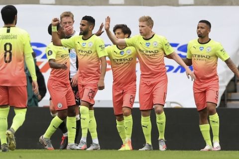 Manchester City's Kevin De Bruyne, second right, celebrates after scoring the opening goal from the penalty spot during the FA Cup sixth round soccer match between Newcastle United and Manchester City at St. James' Park in Newcastle, England, Sunday, June 28, 2020. (Owen Humphreys/Pool via AP)