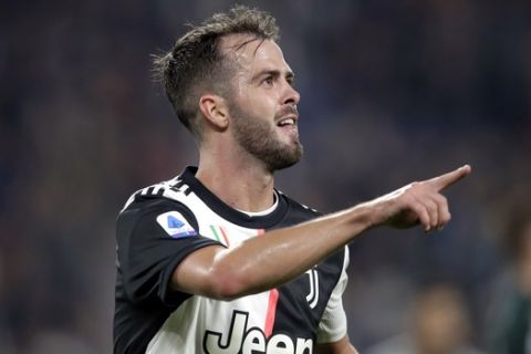 Juventus' Miralem Pjanic celebrates after scoring his side's second goal during a Serie A soccer match between Juventus and Bologna, at the Allianz stadium in Turin, Italy, Saturday, Oct.19, 2019. (AP Photo/Luca Bruno)